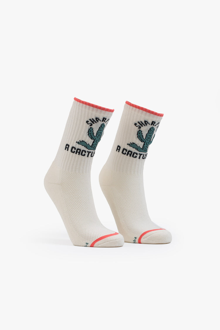 Side view classic tube socks in white with black lettering, peach trim and a green cactus graphic on the front.
