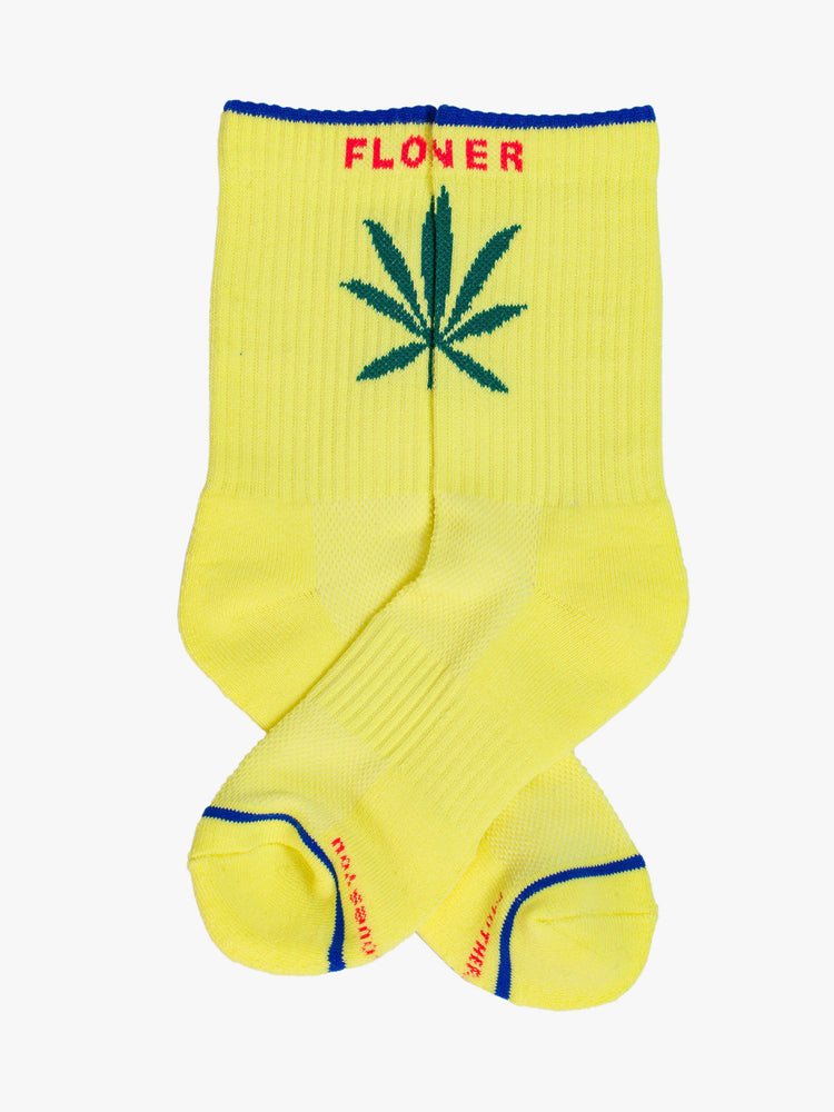 Image of classic yellow tube socks with hot pink lettering and a weed leaf graphic on the front.