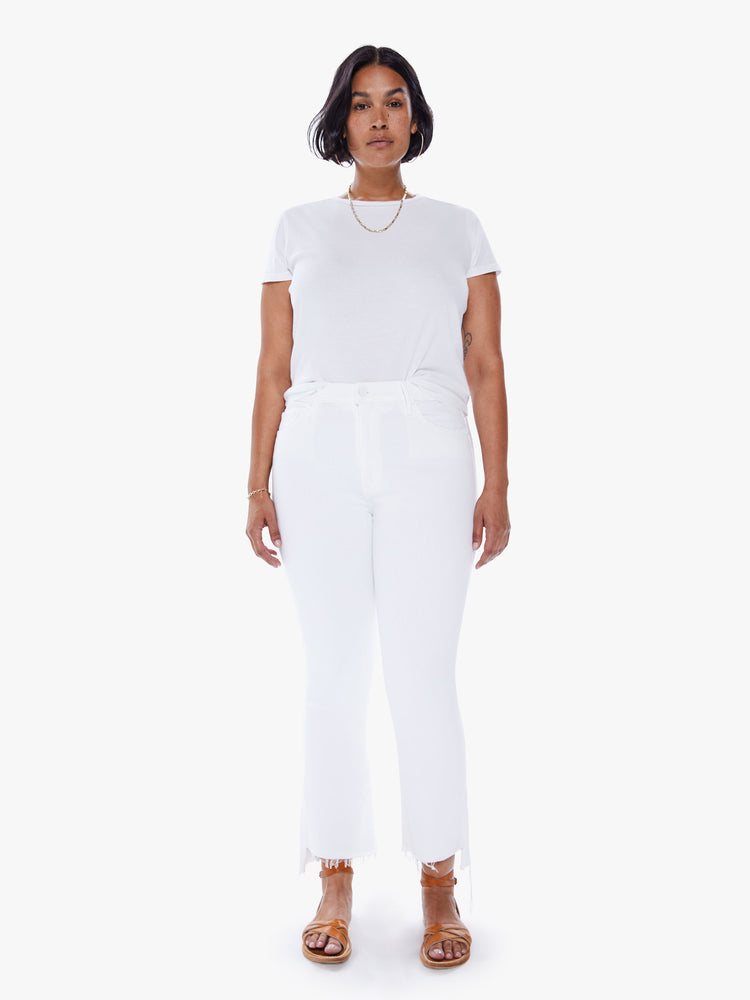 Front view of a womens white wash jean featuring a high rise, bootcut, and a crop step frayed hem.