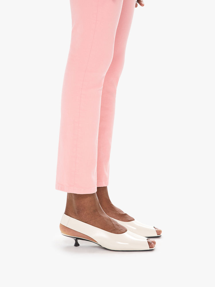 Hem detail view of a women's light pink mid rise jean with a slim straight fit and an ankle length inseam