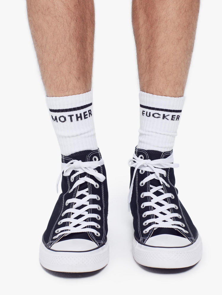front view of men's white tube sock with the words Mother Fucker wearing sneakers