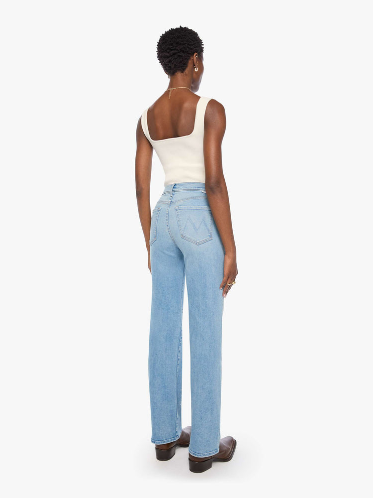 Back view of a woman in a light blue with crystal embellishments high-rise straight-leg jean with a zip fly, 32-inch inseam and a clean hem. 