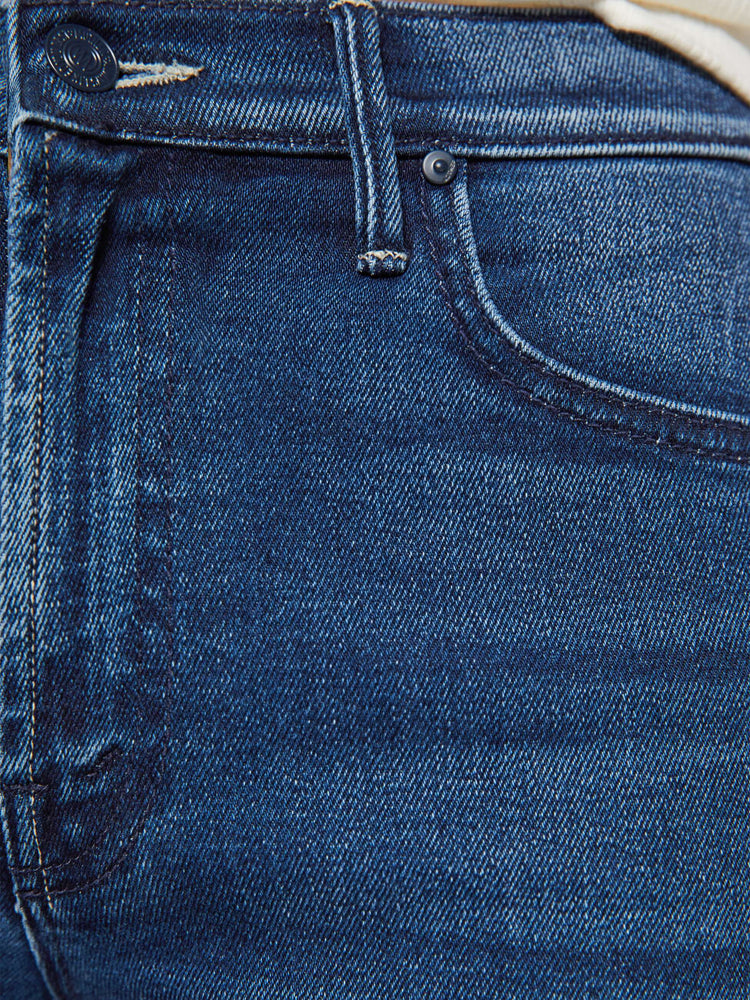 Swatch view of a woman in a dark blue high-rise straight leg jean with a 32-inch inseam and a clean hem.