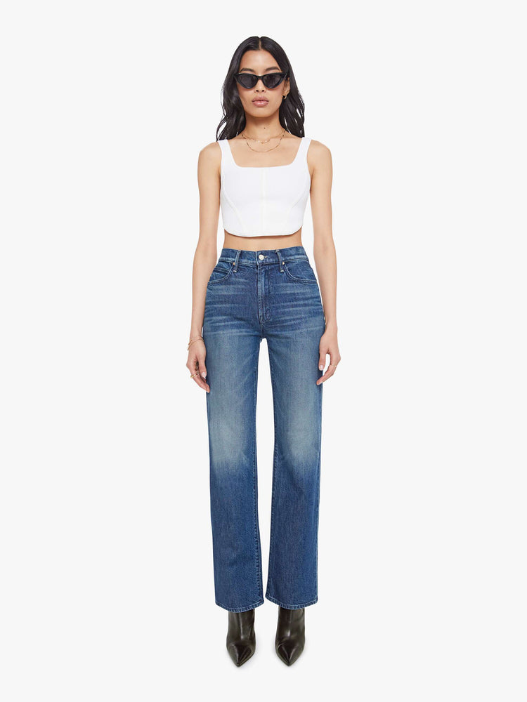 Front view of a woman in a high-rise straight leg jean with a zip fly, 32-inch inseam and a clean hem. 