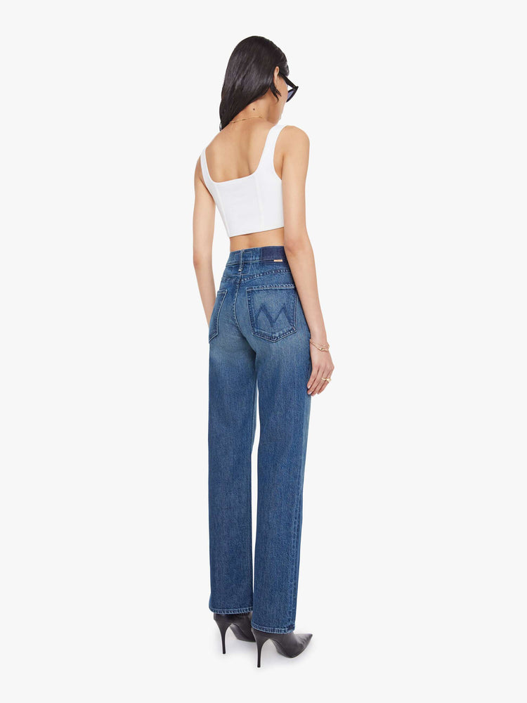 Back view of a woman in a high-rise straight leg jean with a zip fly, 32-inch inseam and a clean hem. 