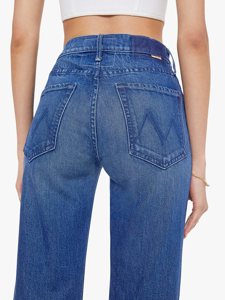 Close up view of a woman in a high-rise straight leg jean with a zip fly, 32-inch inseam and a clean hem. 