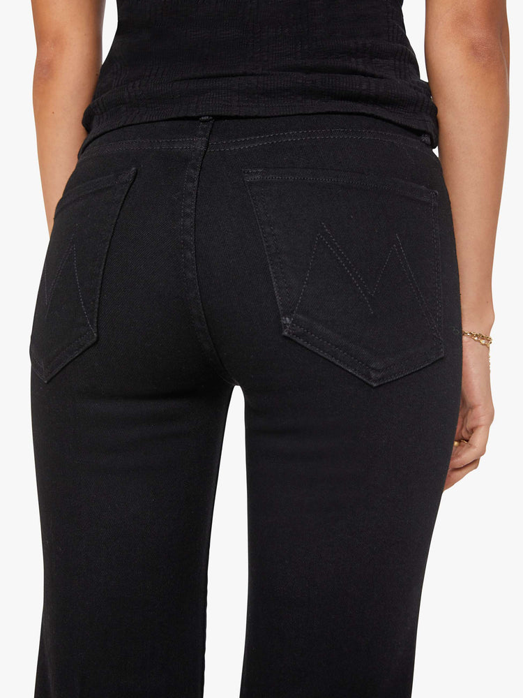 Close up  view of a woman in black high-rise straight leg jean with a 32-inch inseam and a clean hem.