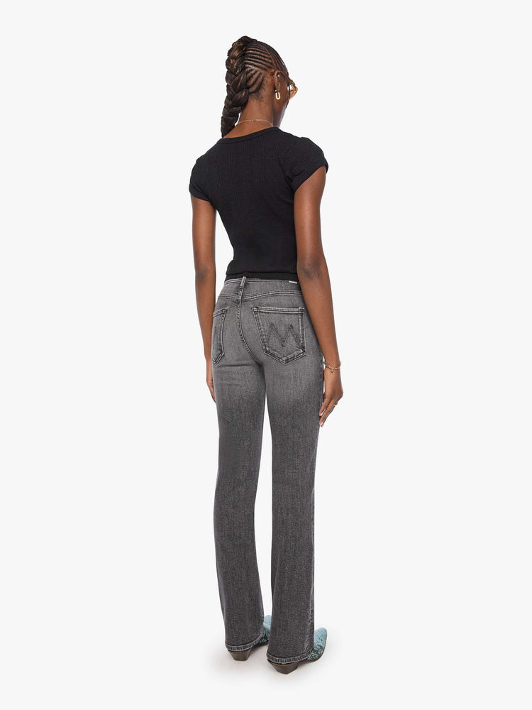 Back view of a woman in a washed black high-rise straight-leg jean with a zip fly, 32-inch inseam and a clean hem.