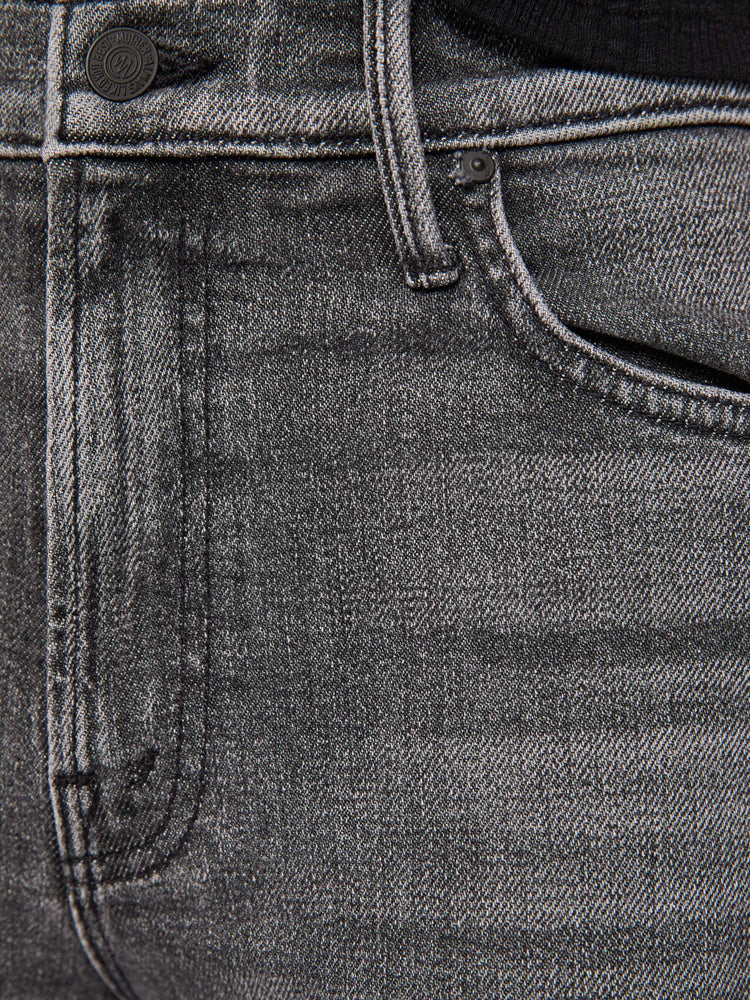 Swatch view of a woman in a washed black high-rise straight-leg jean with a zip fly, 32-inch inseam and a clean hem.