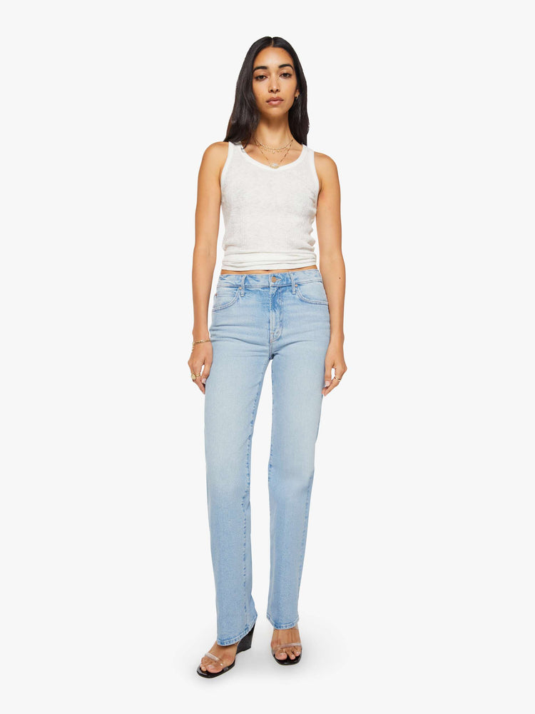 Front view of a woman in a light blue high-rise straight-leg jean with a zip fly, 32-inch inseam and a clean hem.