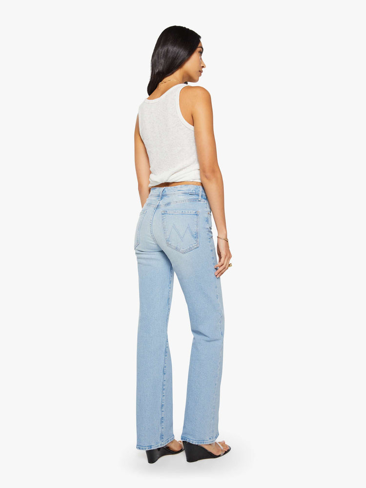 Back view of a woman in a light blue high-rise straight-leg jean with a zip fly, 32-inch inseam and a clean hem.