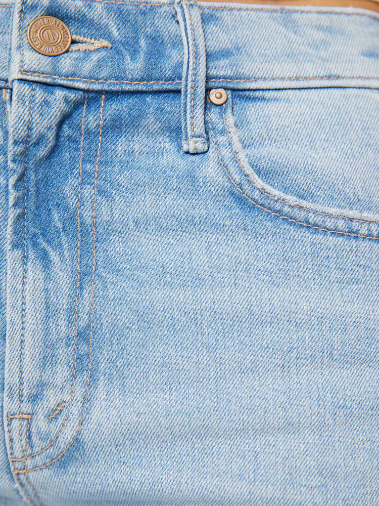 Close up view of a woman in a light blue high-rise straight-leg jean with a zip fly, 32-inch inseam and a clean hem.