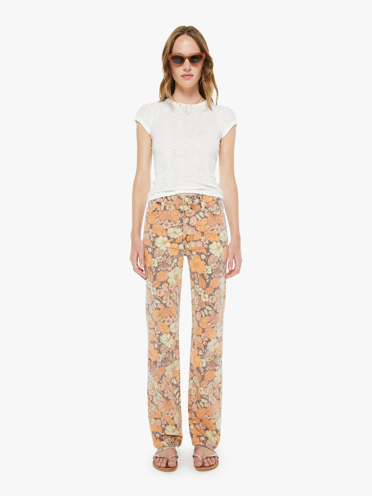 Front view of a woman in floral print high-rise straight-leg jeans with a zip fly, long 32-inch inseam and a clean hem.