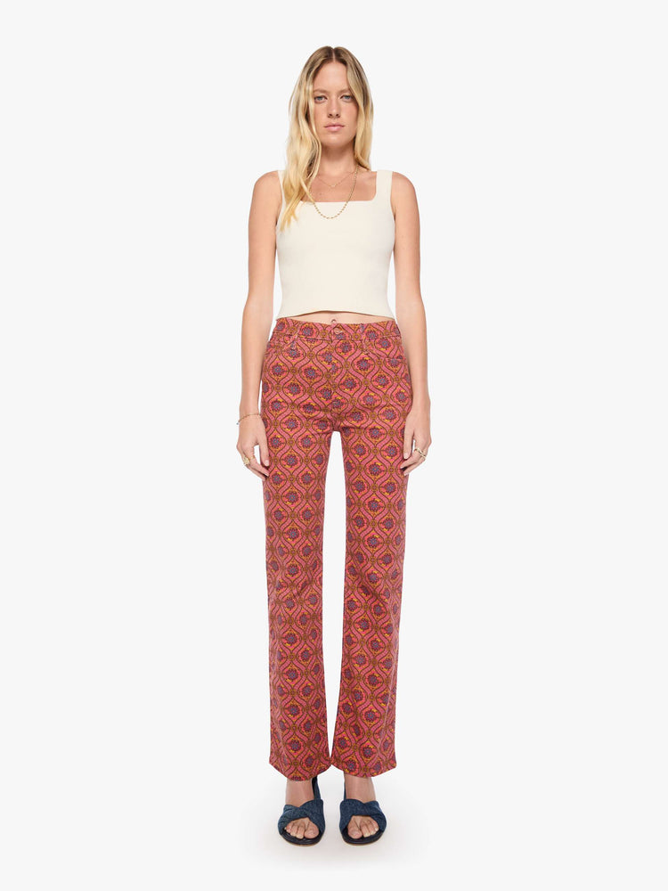 Front view of a woman in a graphic print in pink, yellow, blue and brown high-rise straight-leg jean with a zip fly, 32-inch inseam and a clean hem.