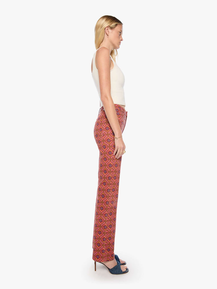Side view of a woman in a graphic print in pink, yellow, blue and brown high-rise straight-leg jean with a zip fly, 32-inch inseam and a clean hem.