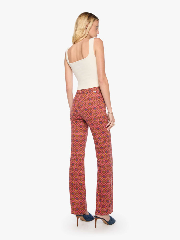 Back view of a woman in a graphic print in pink, yellow, blue and brown high-rise straight-leg jean with a zip fly, 32-inch inseam and a clean hem.