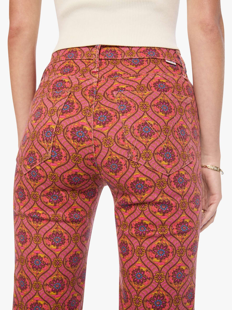 Close up view of a woman in a graphic print in pink, yellow, blue and brown high-rise straight-leg jean with a zip fly, 32-inch inseam and a clean hem.