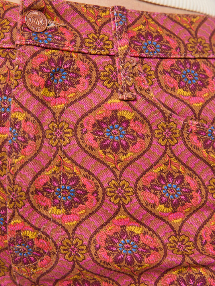 Swatch view of a woman in a graphic print in pink, yellow, blue and brown high-rise straight-leg jean with a zip fly, 32-inch inseam and a clean hem.