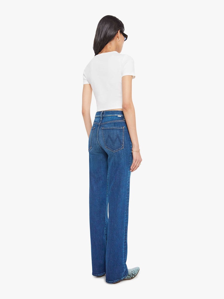 Back view of a med blue high-rise straight-leg jean with a zip fly, 32-inch inseam and a clean hem.