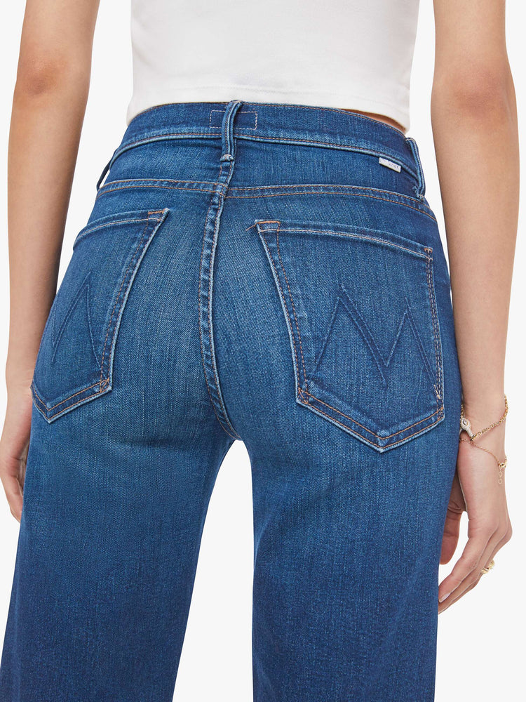 Back close up view of a med blue high-rise straight-leg jean with a zip fly, 32-inch inseam and a clean hem.