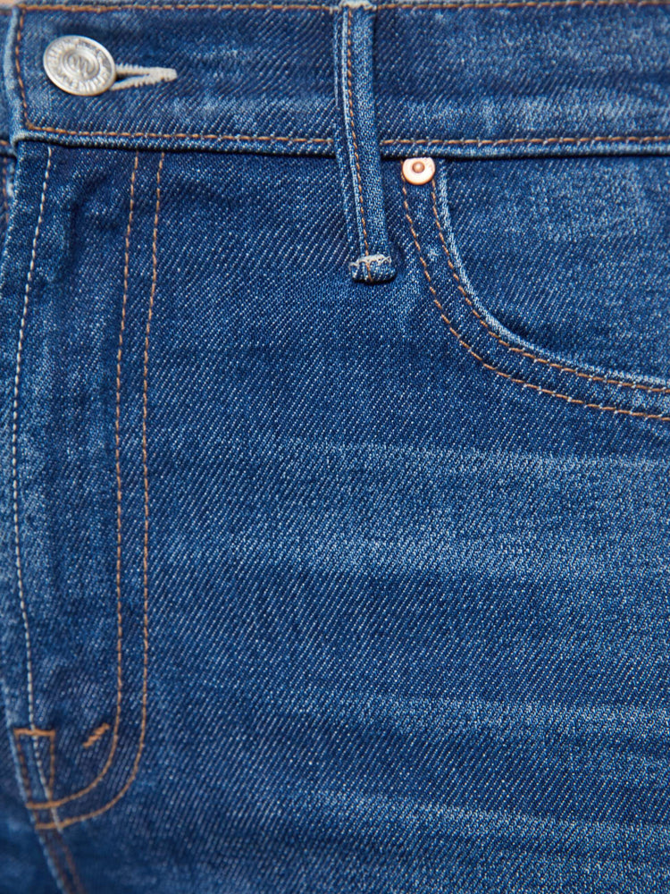 Swatch view of a woman in a dark blue  high-rise straight leg jean with a zip fly, 32-inch inseam and a clean hem. 