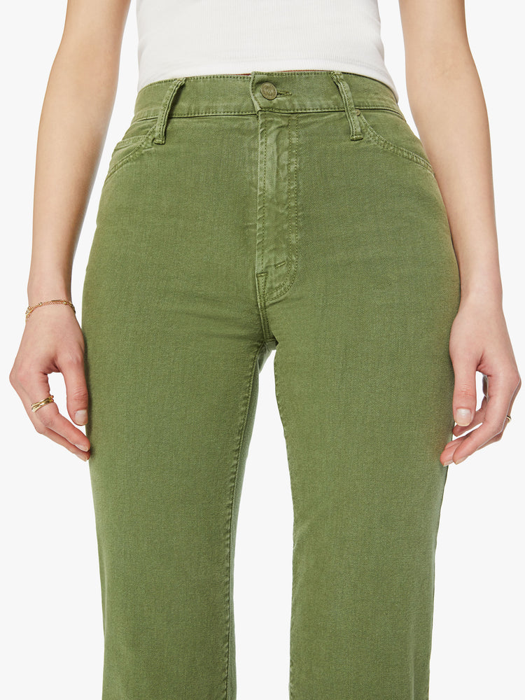 Close up view of a woman high-rise, straight-leg with a 32-inch inseam and a clean hem pant in a stone green color.