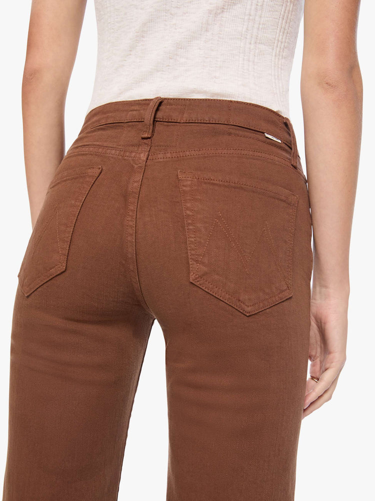 Back view of a woman in a rich brown high-rise straight-leg pant with a zip fly, 32-inch inseam and a clean hem.