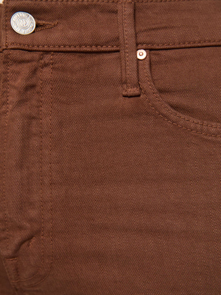 Close up view of a woman in a rich brown high-rise straight-leg pant with a zip fly, 32-inch inseam and a clean hem.