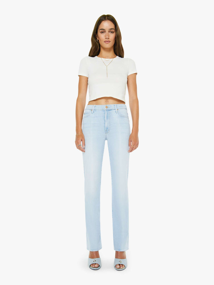 Front view of a woman in a light blue high-rise straight leg jean with a zip fly, 32-inch inseam and a clean hem.