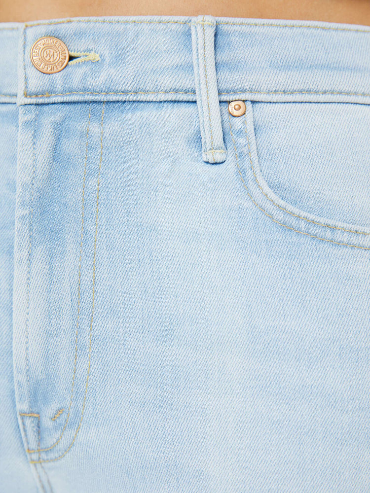 Swatch view of a woman in a light blue high-rise straight leg jean with a zip fly, 32-inch inseam and a clean hem.