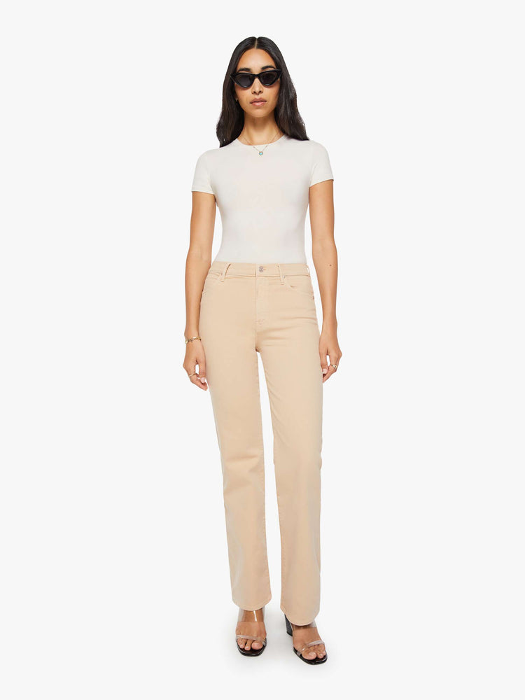 Front view of a woman in a light khaki  high-rise straight leg pant with a zip fly, 32-inch inseam and a clean hem. 
