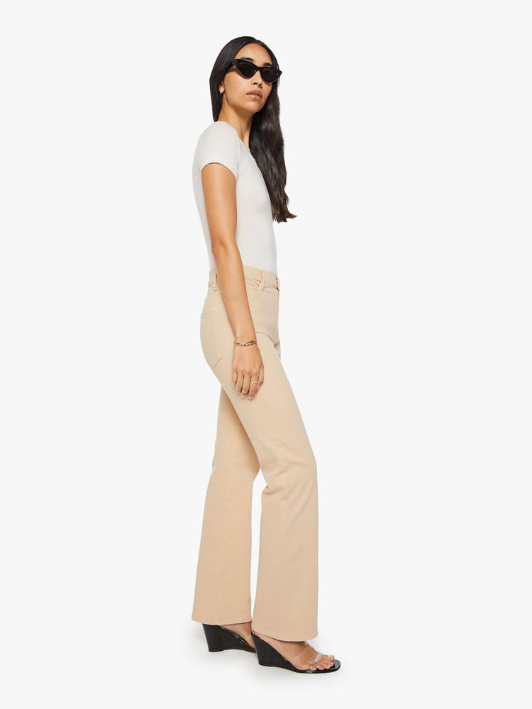 Side view of a woman in a light khaki  high-rise straight leg pant with a zip fly, 32-inch inseam and a clean hem. 
