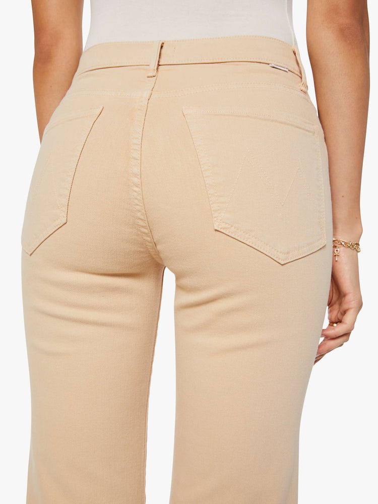 Close up view of a woman in a light khaki  high-rise straight leg pant with a zip fly, 32-inch inseam and a clean hem. 