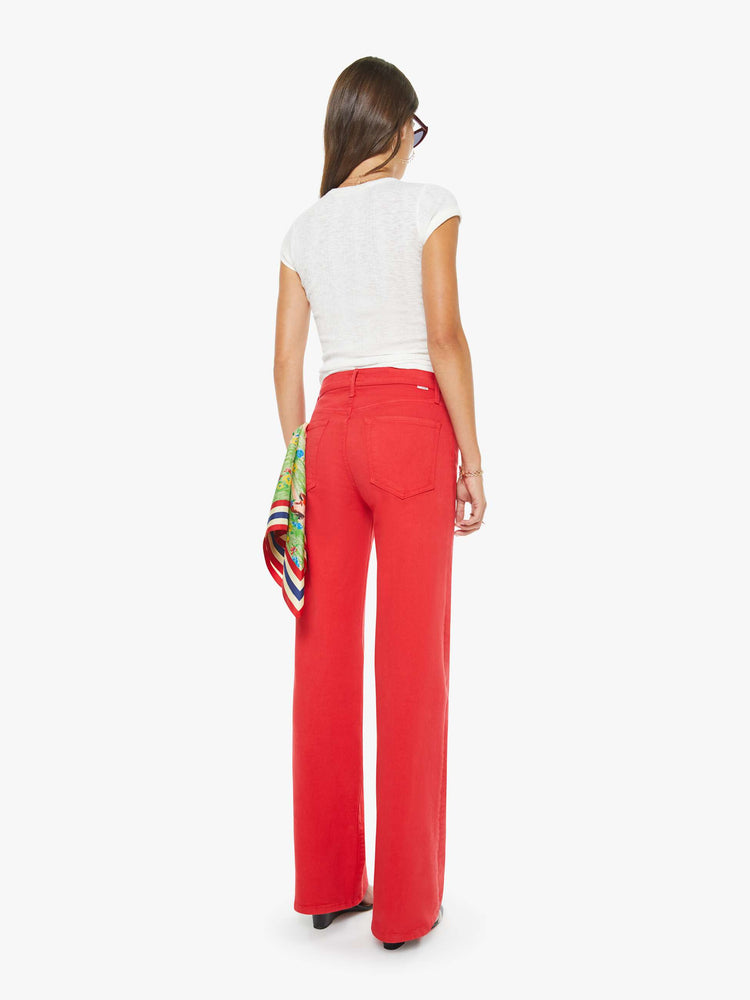 Back view of a woman in a red high-rise straight-leg jean with a zip fly, 32-inch inseam and a clean hem.