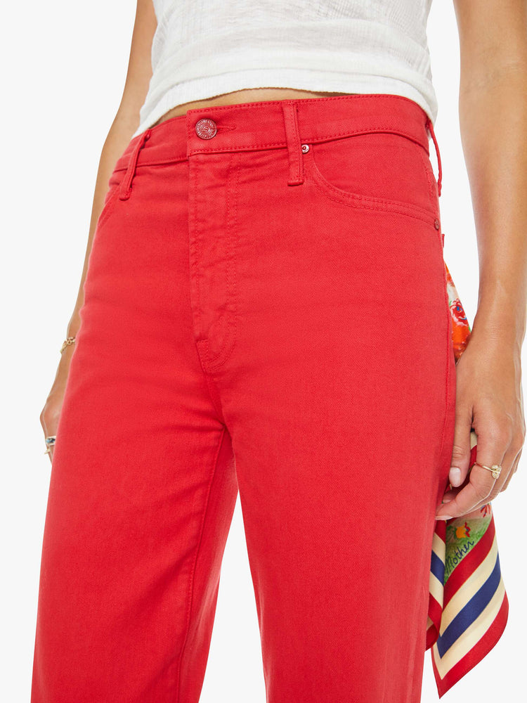 Close up view of a woman in a red high-rise straight-leg jean with a zip fly, 32-inch inseam and a clean hem.