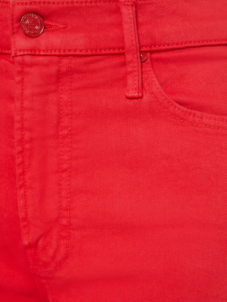 Swatch view of a woman in a red high-rise straight-leg jean with a zip fly, 32-inch inseam and a clean hem.