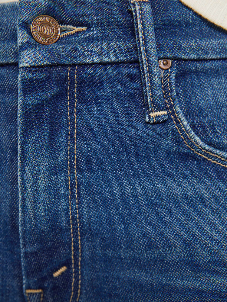 Swatch view of a woman in a mid blue skinny jean has a high rise with a zip fly, 29-inch inseam and a clean hem.