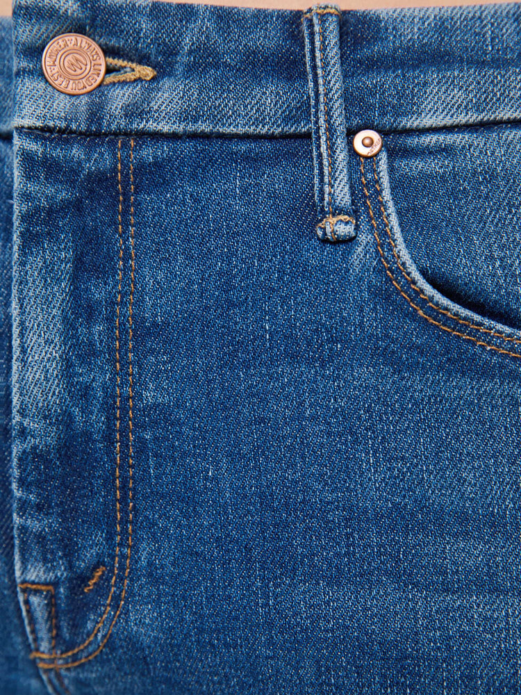 Swatch view of woman in a med blue skinny jean with a high rise with a zip fly, 30 3/4 inch inseam and a clean hem.