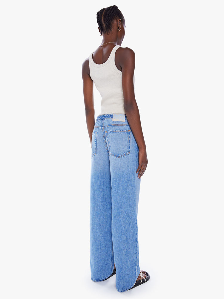 Back view of a woman wide-leg jean feature a drawstring waist, zip fly, slit pockets and a long 30-inch inseam in a mid-blue wash.