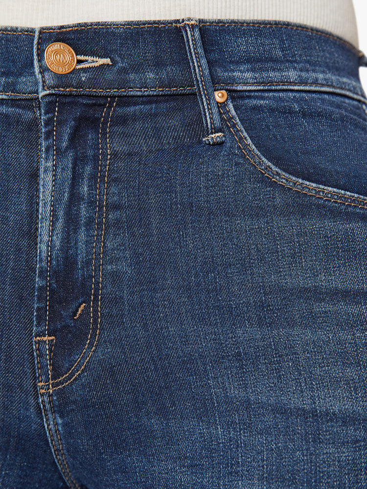 Swatch view of a woman mid-rise flare with a long 34-inch inseam and a clean hem in a dark blue wash.