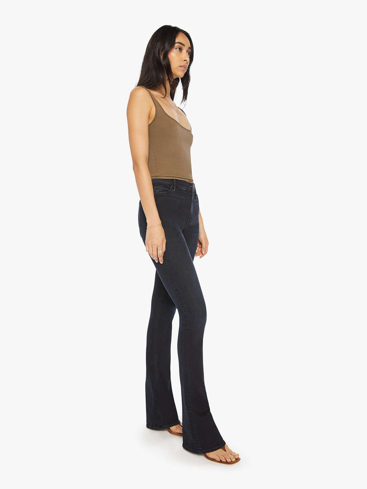 Front 3/4 view of a woman classic mid-rise bootcut with a long 34-inch inseam and a clean hem in a dark blue wash.