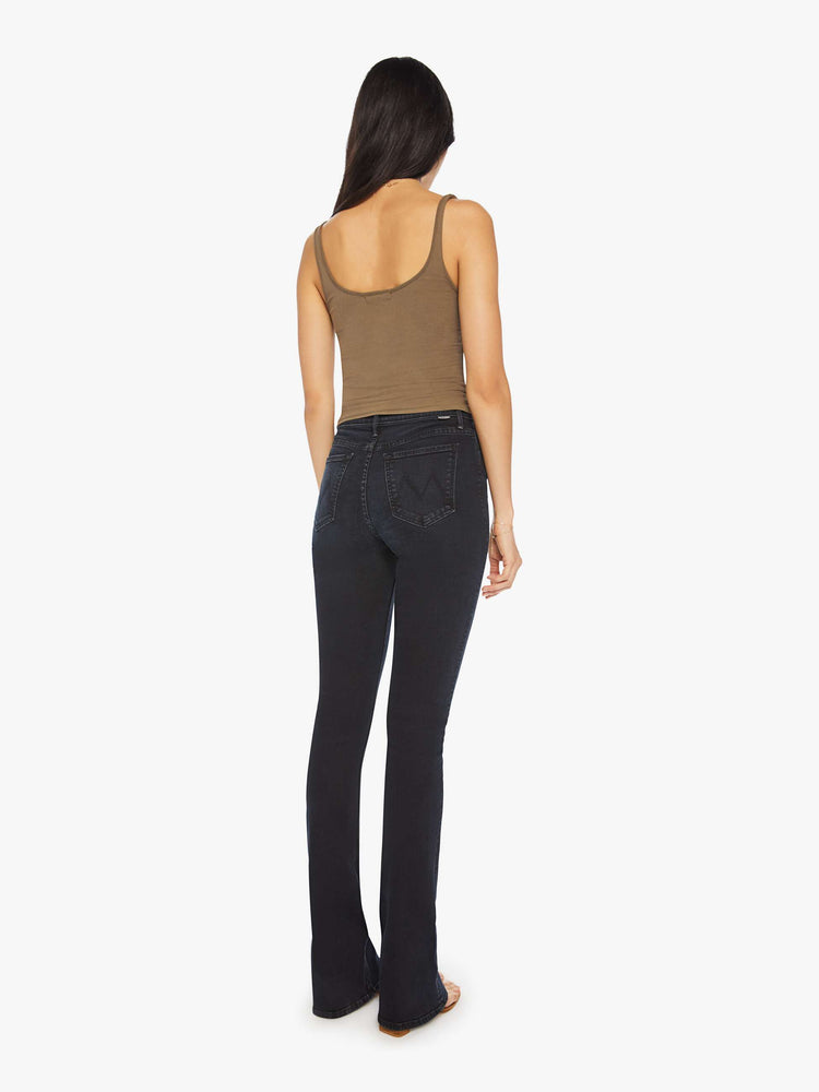 Back view of a woman classic mid-rise bootcut with a long 34-inch inseam and a clean hem in a dark blue wash.