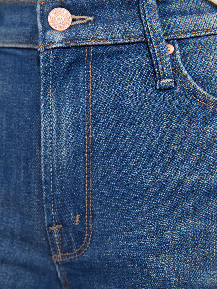 Swatch view of a woman in mid blue skinny flare with a mid rise, zip fly and a long 34-inch inseam with a clean hem.