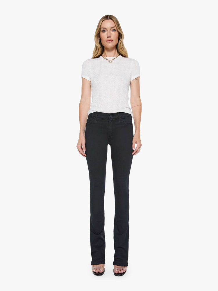 Front 3/4 side view of a womens black wash jean featuring a mid rise and skinny flare.