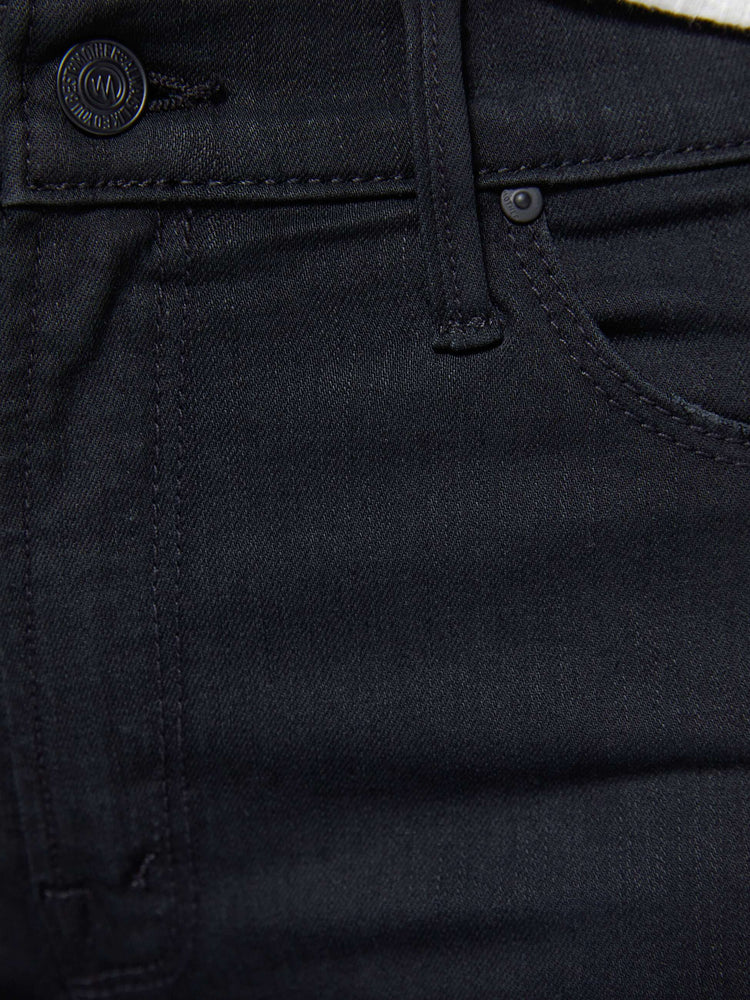 Swatch close up view of a womens black wash jean featuring a mid rise and skinny flare.