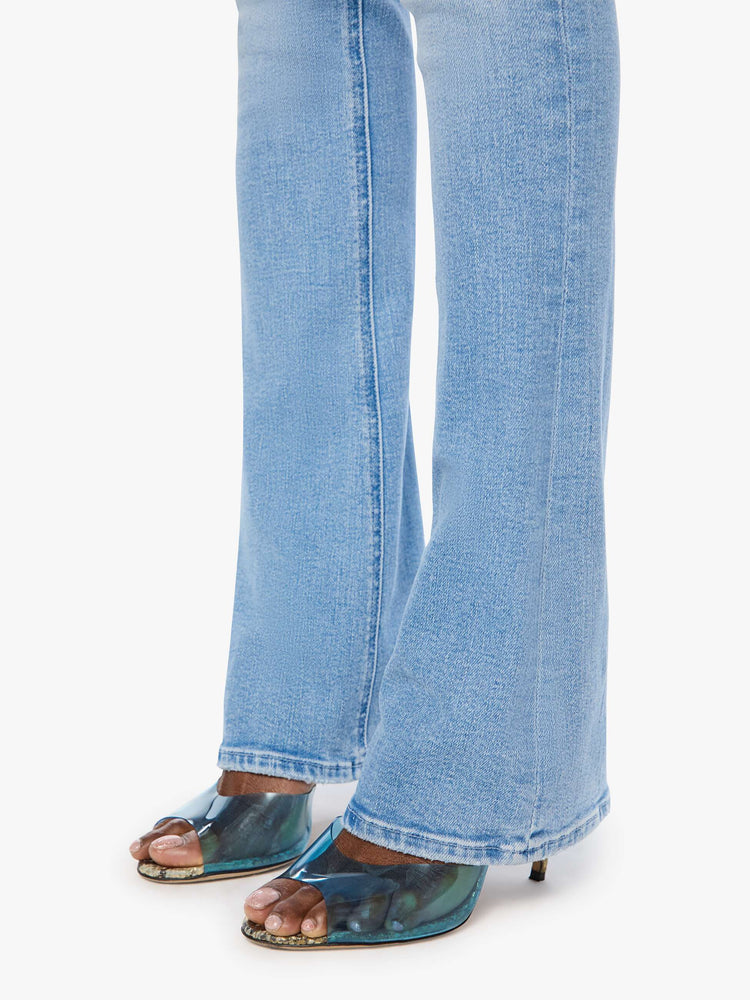 Hem view of a woman in a light blue classic skinny flare with a mid rise, zip fly and a long 34-inch inseam with a clean hem.
