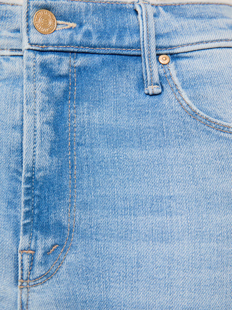 Swatch view of a woman in a light blue classic skinny flare with a mid rise, zip fly and a long 34-inch inseam with a clean hem.