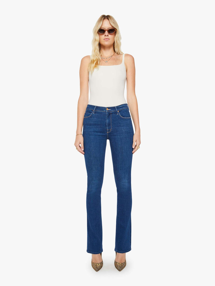Front view of a woman in a skinny flare with a mid rise, zip fly and a long 34-inch inseam with a clean hem.