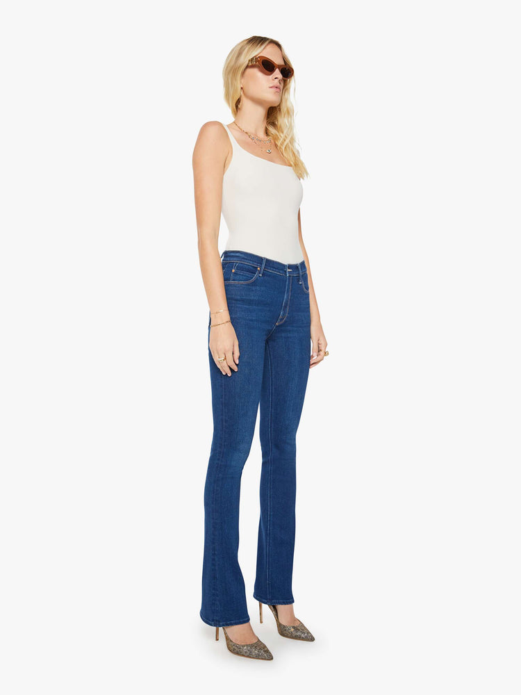 Front view of a woman in a skinny flare with a mid rise, zip fly and a long 34-inch inseam with a clean hem.