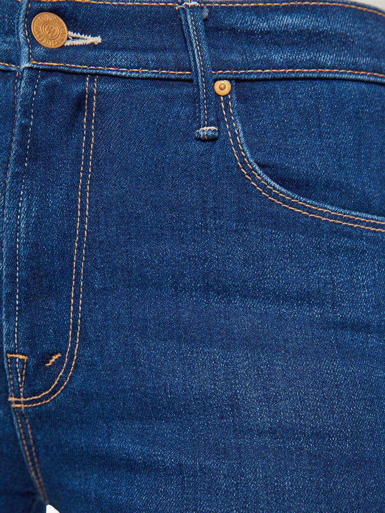 Swatch view of a woman in a skinny flare with a mid rise, zip fly and a long 34-inch inseam with a clean hem.
